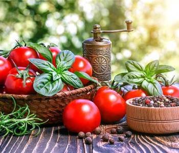 cherry tomatoes ,  basil, pepper and pepper-mill on wooden board