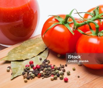tomatoes and tomato juice on a wooden table