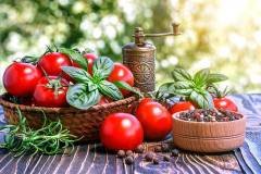 cherry tomatoes ,  basil, pepper and pepper-mill on wooden board