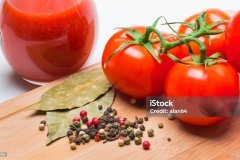 tomatoes and tomato juice on a wooden table